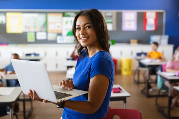 Teacher_Using_Laptop_In_Classroom_original_3111555 Teacher_Using_Laptop_In_Classroom_original_3111555